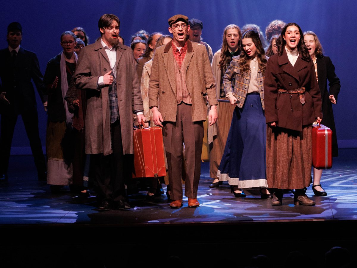 Anastasia: travelers with suitcases singing