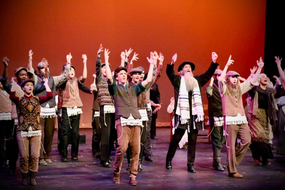 Drama students on stage in Fiddler on the Roof