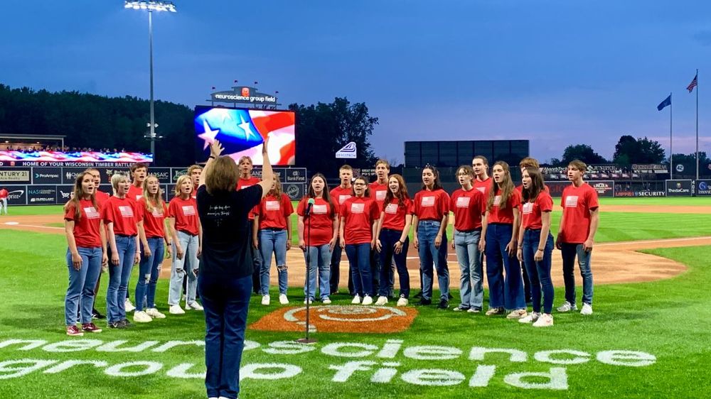 The Trouvères singing at a ballpark